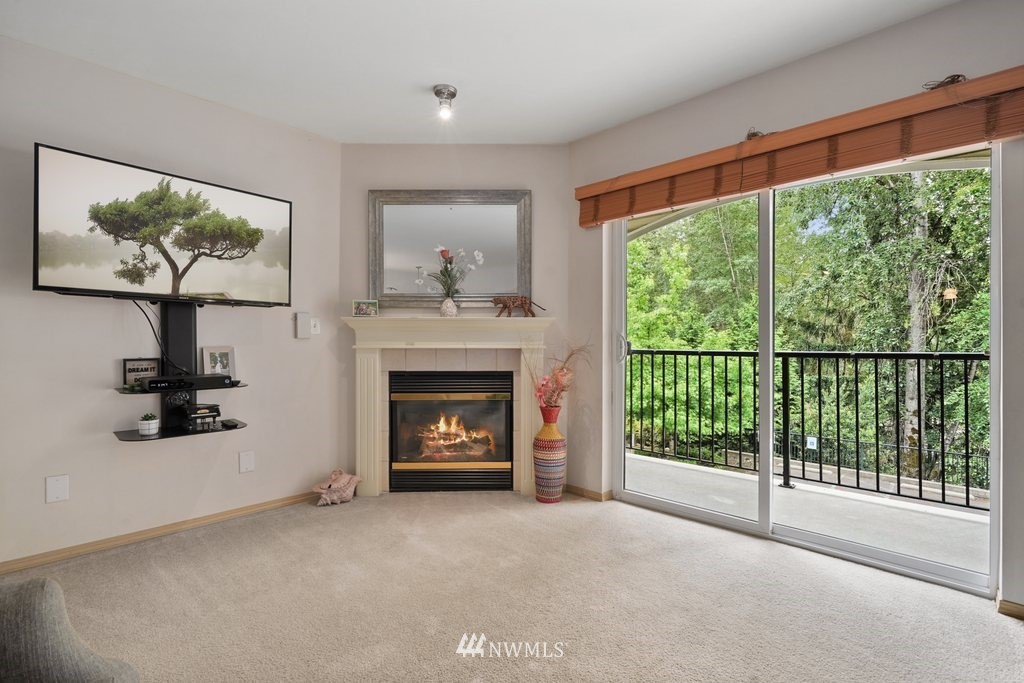 10709 Valley View Road, Unit A105 Bothell, WA 98011 - Photo 6 of 26 a view of an empty room with a fireplace and window