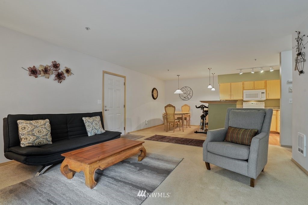 10709 Valley View Road, Unit A105 Bothell, WA 98011 - Photo 8 of 26 a living room with furniture and wooden floor