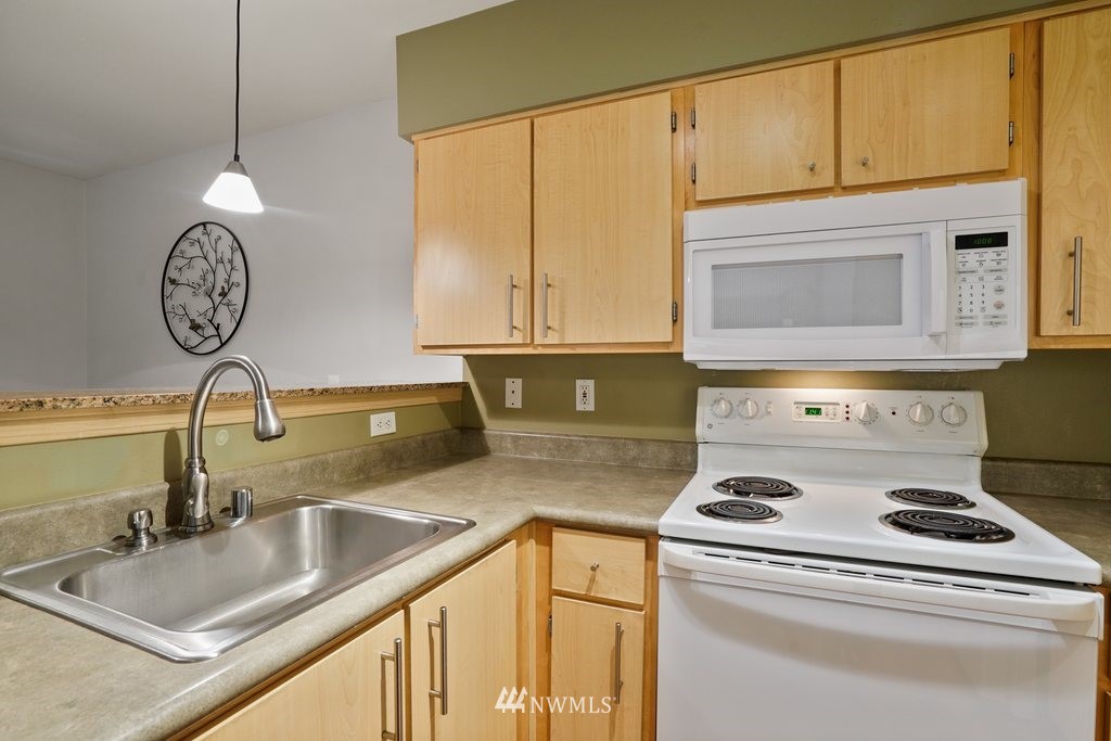 10709 Valley View Road, Unit A105 Bothell, WA 98011 - Photo 10 of 26 a kitchen with a stove and a sink