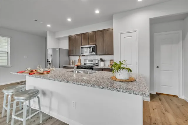 a kitchen with a sink and a stove top oven