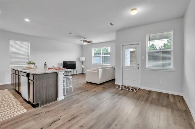 a living room with furniture and a wooden floor