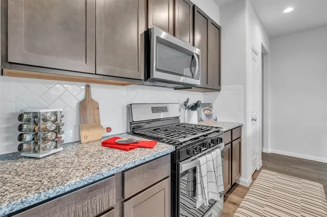 a kitchen with stainless steel appliances granite countertop a stove and a sink
