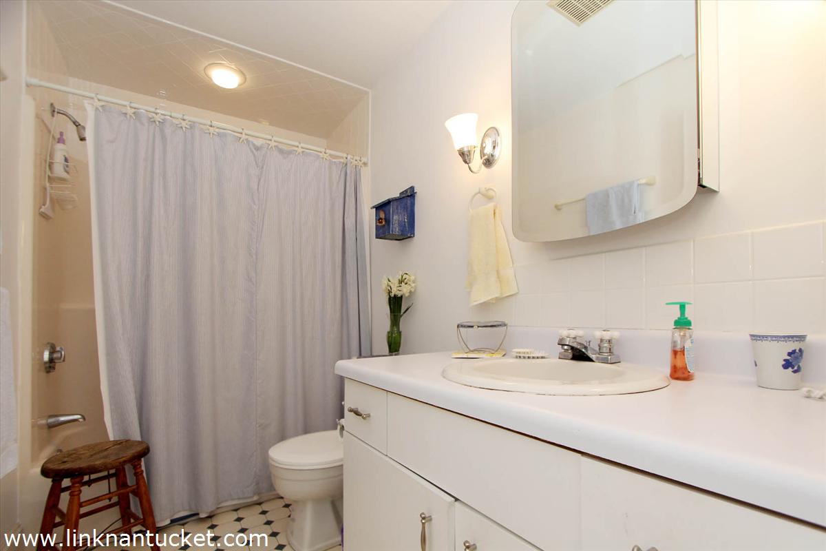 8 C Cliff Road, Unit C Nantucket, MA 02554 - Photo 16 of 20 a bathroom with a sink toilet and shower