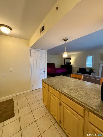 a spacious bathroom with a granite countertop sink a mirror and a shower