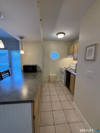 a kitchen with stainless steel appliances granite countertop a sink and a stove