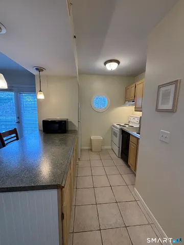 a kitchen with stainless steel appliances granite countertop a sink and a stove