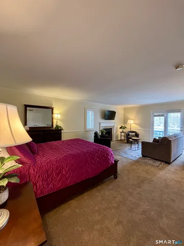 a spacious bedroom with a bed and a couch