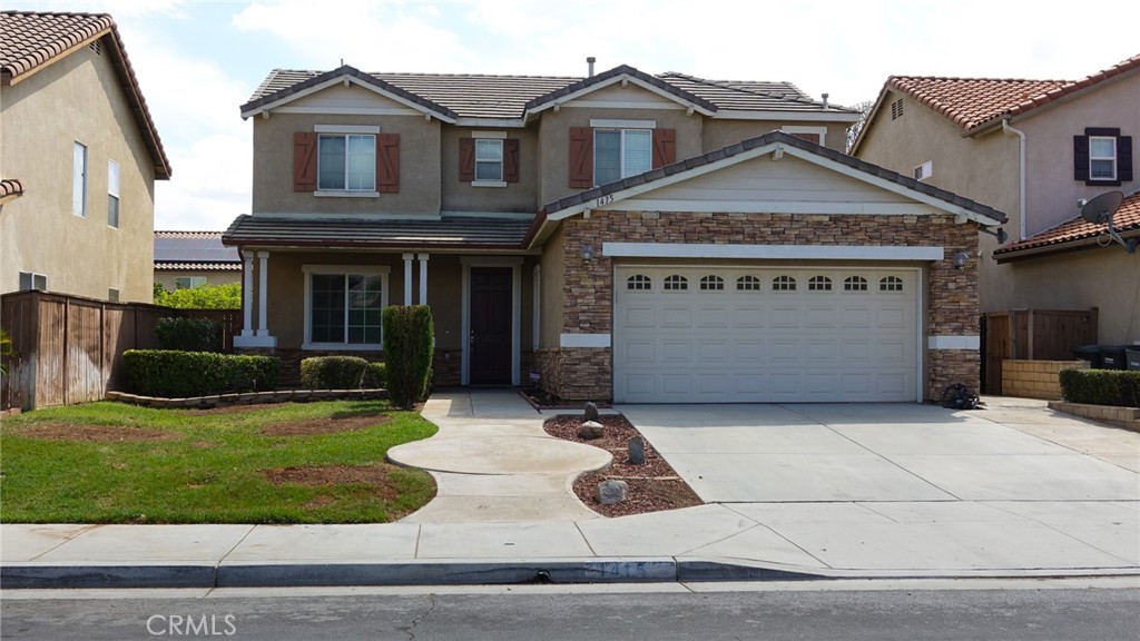 1415 Sunflower Way Perris, CA 92571 - Photo 2 of 39 a front view of a house with a yard
