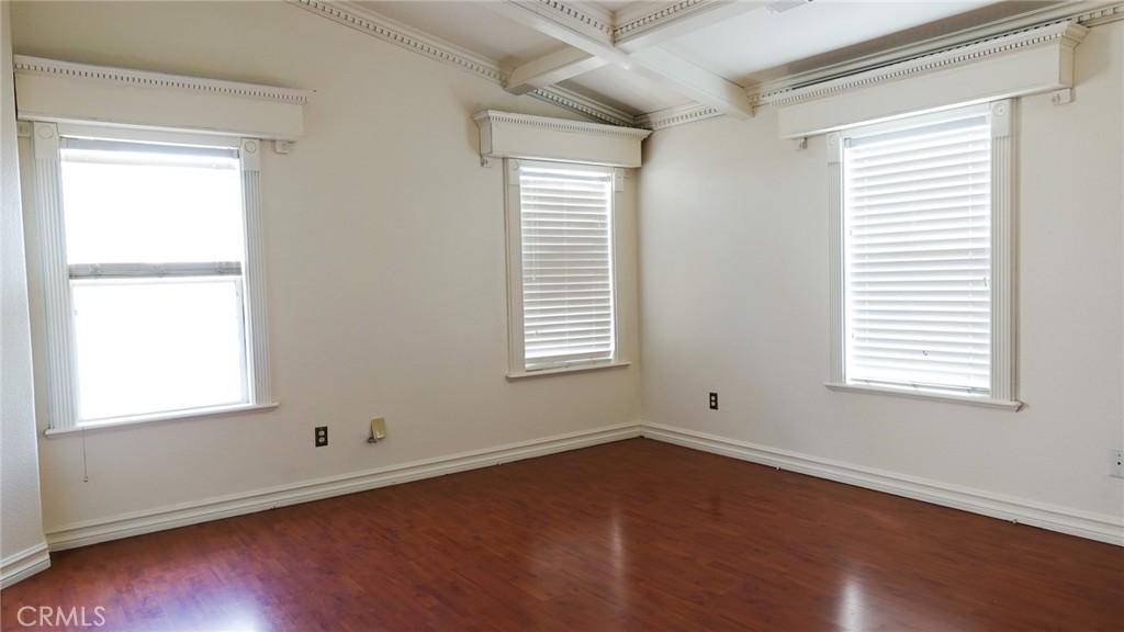 1415 Sunflower Way Perris, CA 92571 - Photo 22 of 39 an empty room with wooden floor and windows
