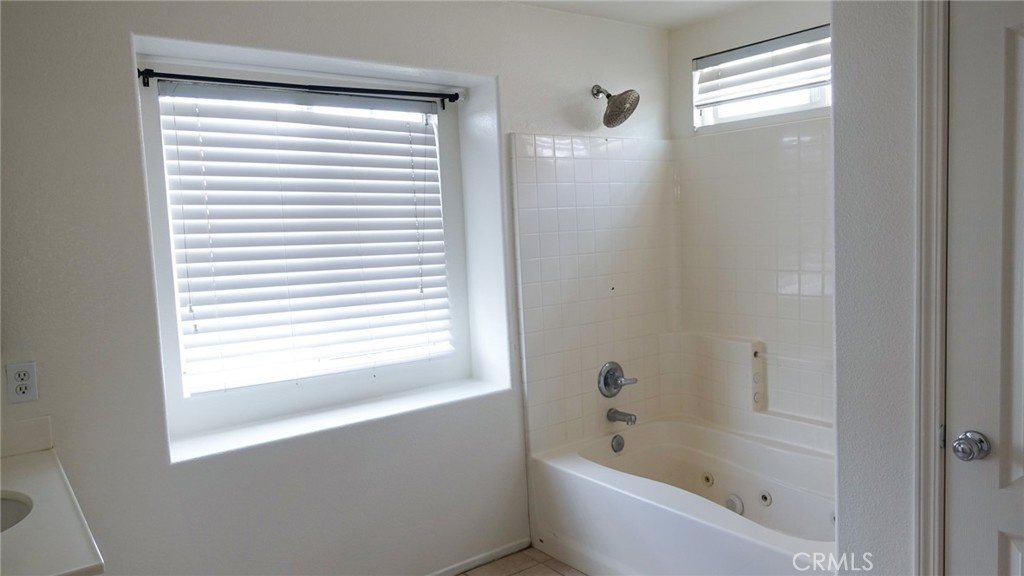 1415 Sunflower Way Perris, CA 92571 - Photo 26 of 39 a bathroom with a bathtub next to a window