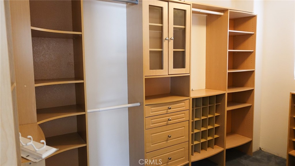 1415 Sunflower Way Perris, CA 92571 - Photo 27 of 39 a view of walk in closet with empty racks