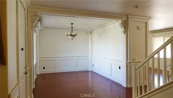 a view of a hallway with wooden floor and entryway