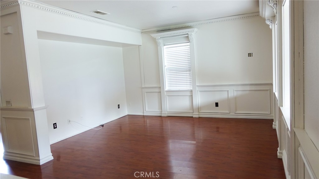 1415 Sunflower Way Perris, CA 92571 - Photo 9 of 39 an empty room with wooden floor and windows