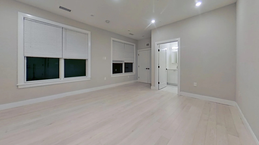 197 Green Street, Unit 207 Boston, MA 02130 - Photo 3 of 4 a view of an empty room with windows