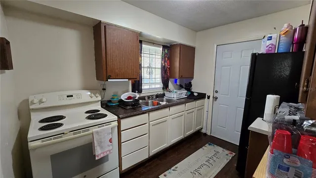 a kitchen with stainless steel appliances a stove microwave and refrigerator