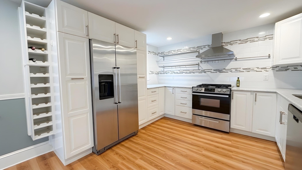 114 Curve Street Dedham, MA 02026 - Photo 6 of 27 a kitchen with stainless steel appliances a refrigerator and a hard wood floor