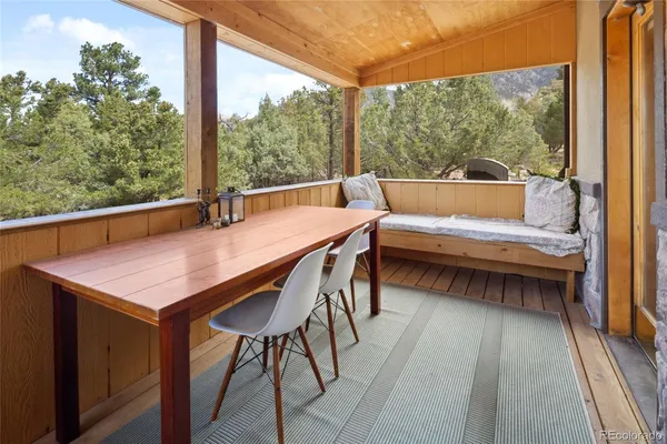a balcony view with a large window and couch