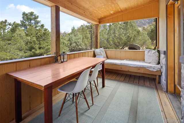 a balcony view with a large window and couch