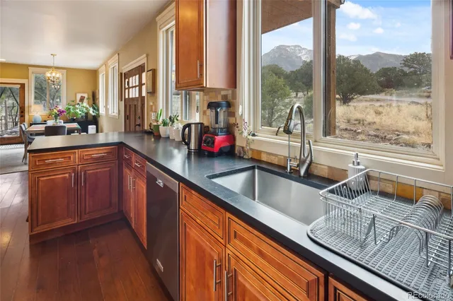 a kitchen with a large window and cabinets