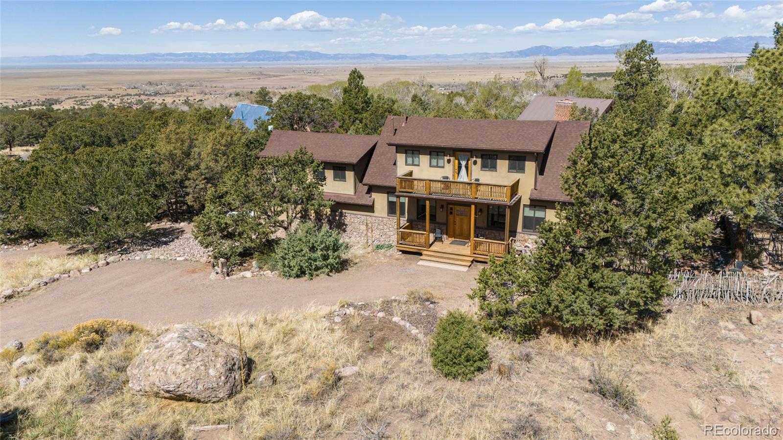 147 Moonlight Way Crestone, CO 81131 - Photo 2 of 47 an aerial view of a house with a garden and lake view