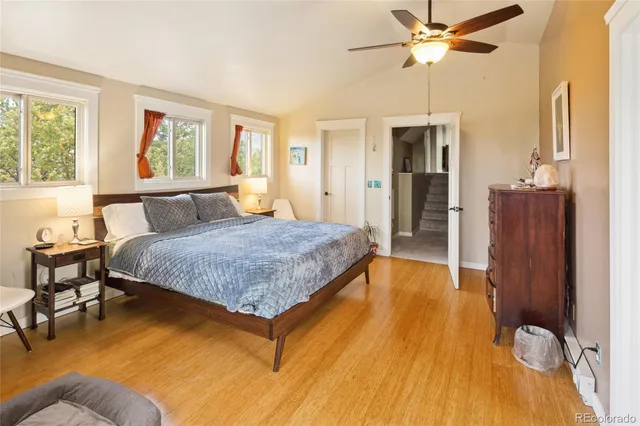 a view of a bedroom with furniture and a window
