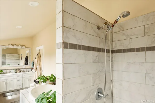 a living room with a bed and a dresser next to a window