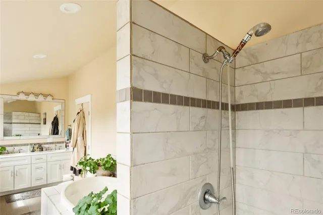 a living room with a bed and a dresser next to a window