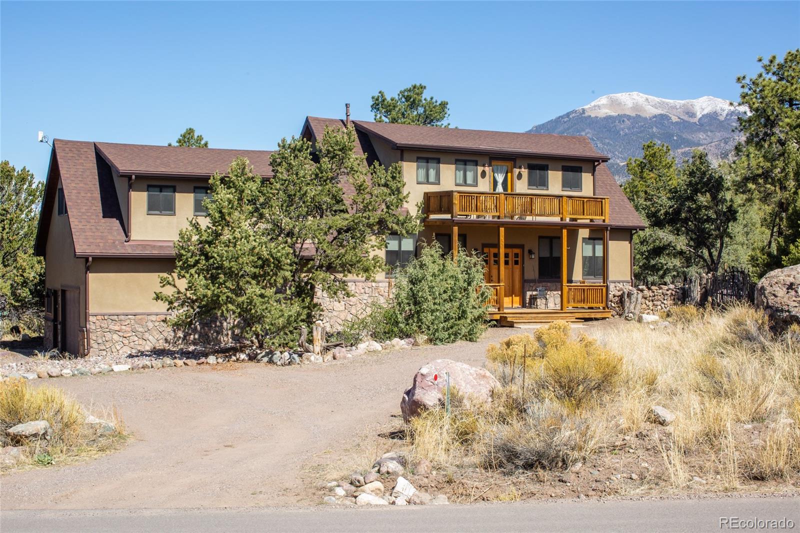 147 Moonlight Way Crestone, CO 81131 - Photo 3 of 47 a view of a white house with a yard covered in snow