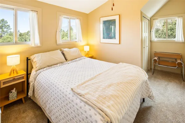 a bedroom with a bed and window