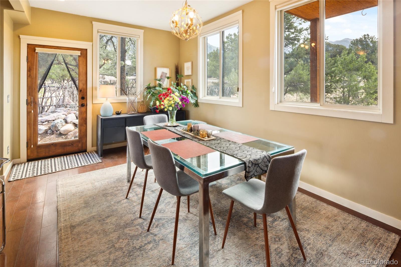 147 Moonlight Way Crestone, CO 81131 - Photo 9 of 47 a dining room with furniture a chandelier and wooden floor