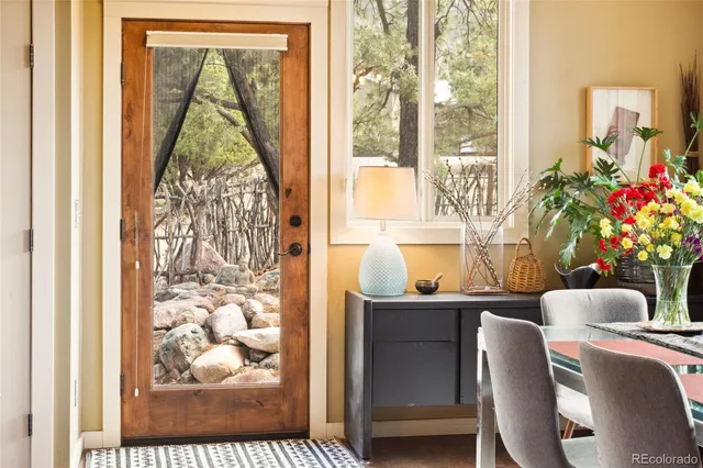 a dining room with furniture and wooden floor