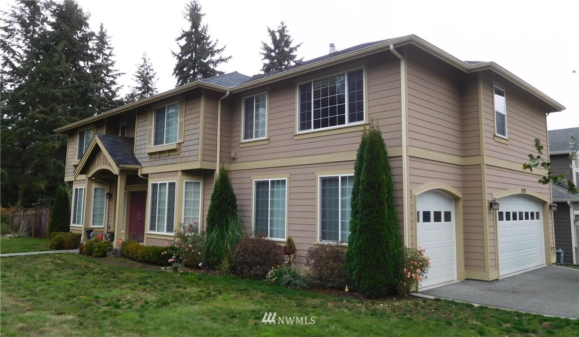 2229 239th Place Southwest Bothell, WA 98021 - Photo 1 of 1 a front view of a house with a yard and garage