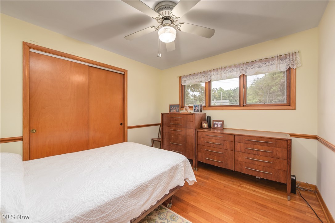 4712 Hillside Road Independence, OH 44131 - Photo 25 of 47 Bedroom with a closet, light wood-style flooring, and a ceiling fan
