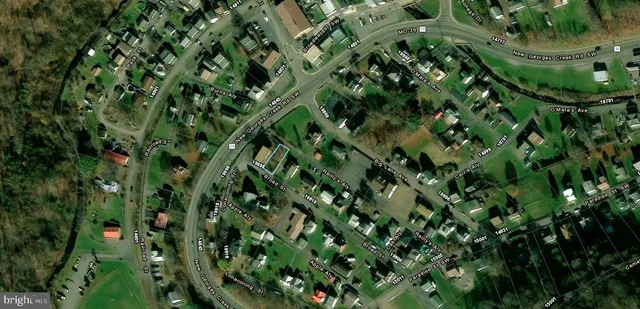 wooden floor with a white comforter and a shower curtain