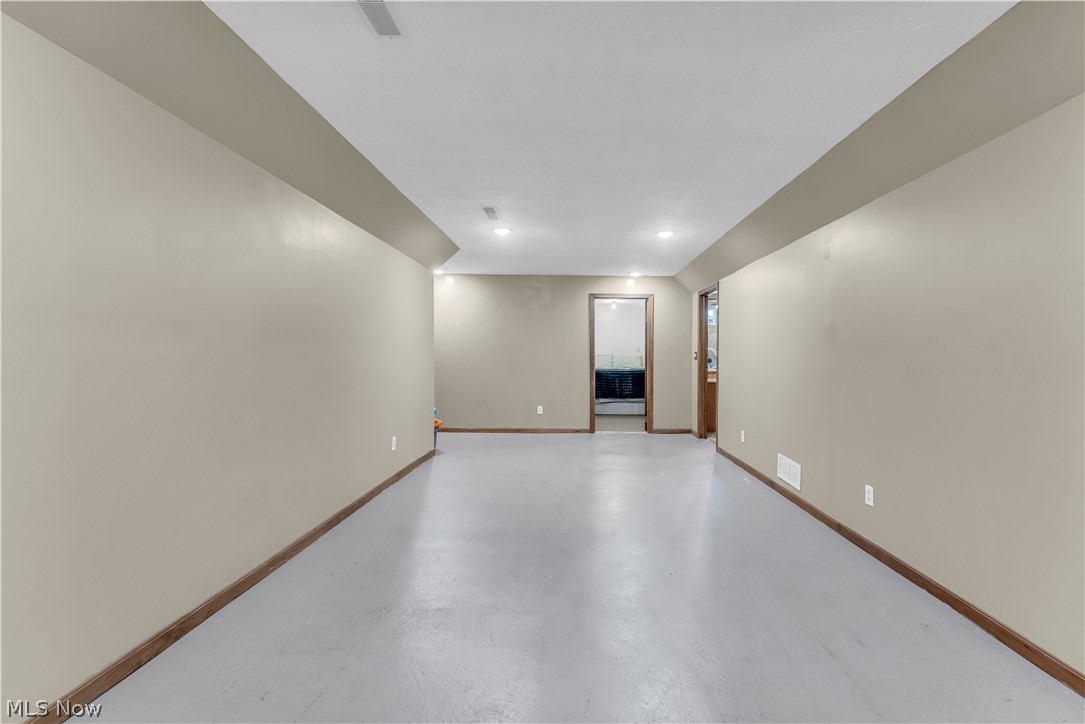 408 River Road Canal Fulton, OH 44614 - Photo 33 of 42 Spacious room featuring neutral painted walls, wood-finish baseboards, and a light-colored floor