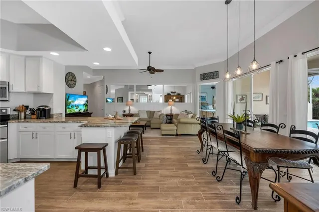 a large dining space with furniture window and wooden floor