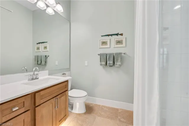 a bathroom with a sink a toilet and mirror