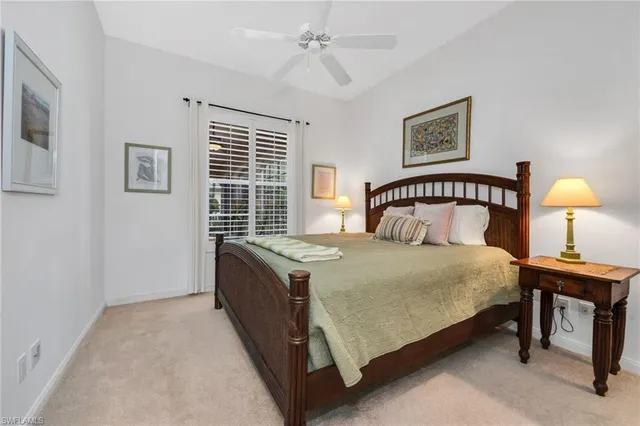 a bedroom with a bed lamp and a window