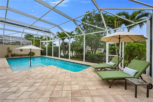 a view of a patio with table and chairs under an umbrella