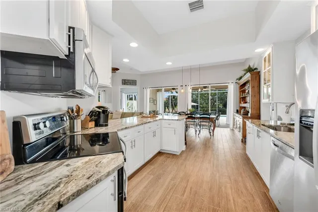 a kitchen with stainless steel appliances granite countertop a stove oven and a refrigerator