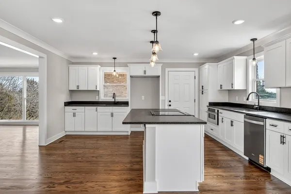 a kitchen with stainless steel appliances granite countertop a sink stove and refrigerator