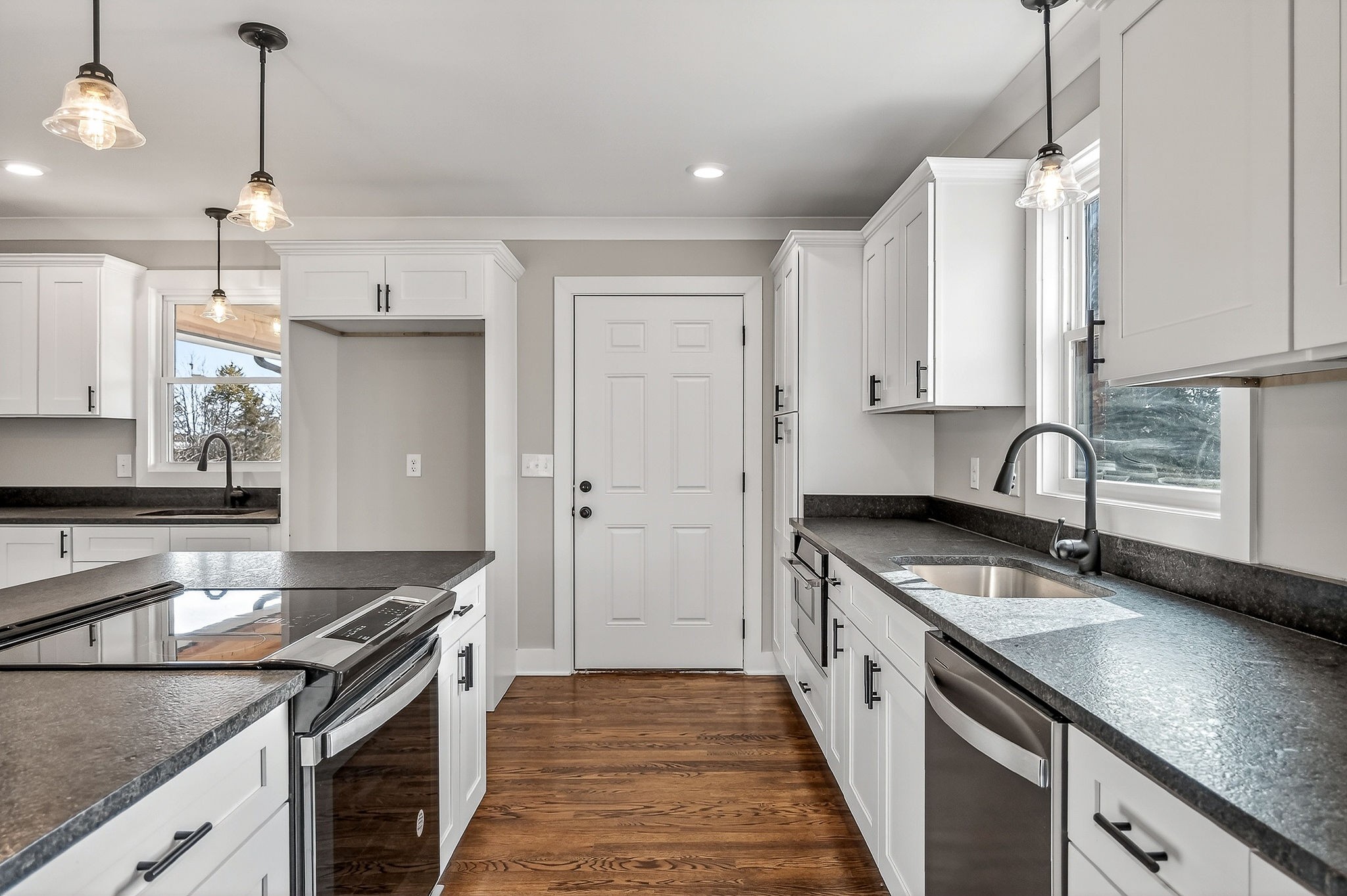 698 Mike Muncey Road McMinnville, TN 37110 - Photo 13 of 71 a kitchen with stainless steel appliances granite countertop a sink stove and refrigerator