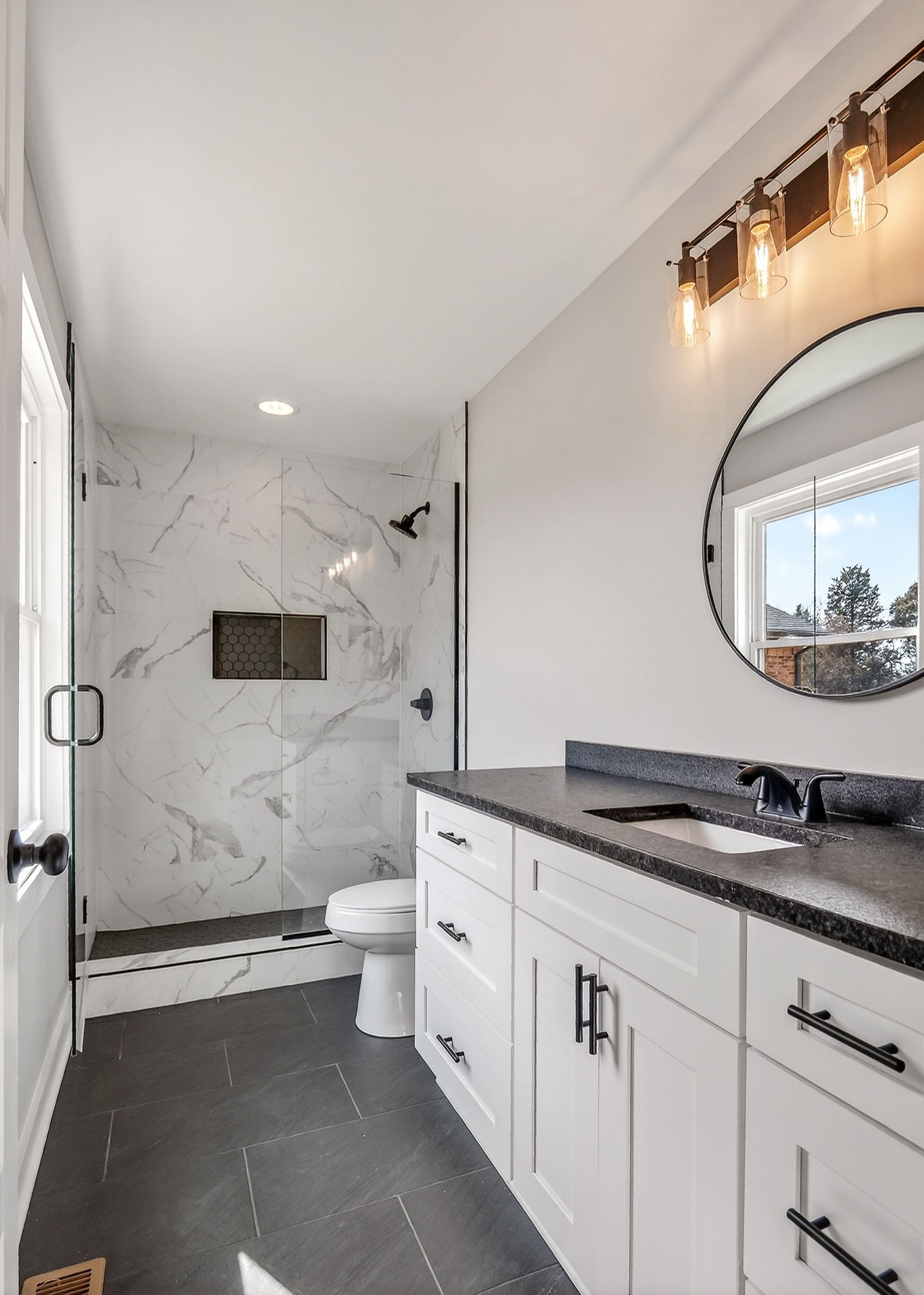698 Mike Muncey Road McMinnville, TN 37110 - Photo 19 of 71 a spacious bathroom with a granite countertop sink a toilet a mirror and bathtub