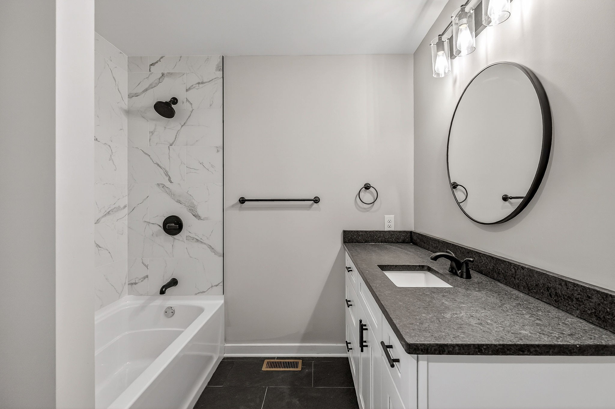 698 Mike Muncey Road McMinnville, TN 37110 - Photo 23 of 71 a bathroom with a granite countertop sink a mirror and a bathtub