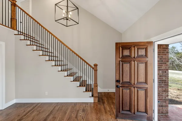 a view of an entryway with wooden floor