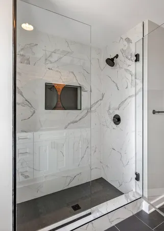 a view of an empty room with wooden floor and a ceiling fan