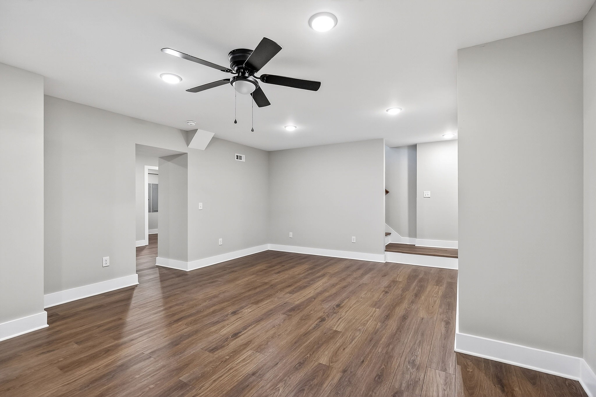 698 Mike Muncey Road McMinnville, TN 37110 - Photo 43 of 71 a view of an empty room with wooden floor and a ceiling fan