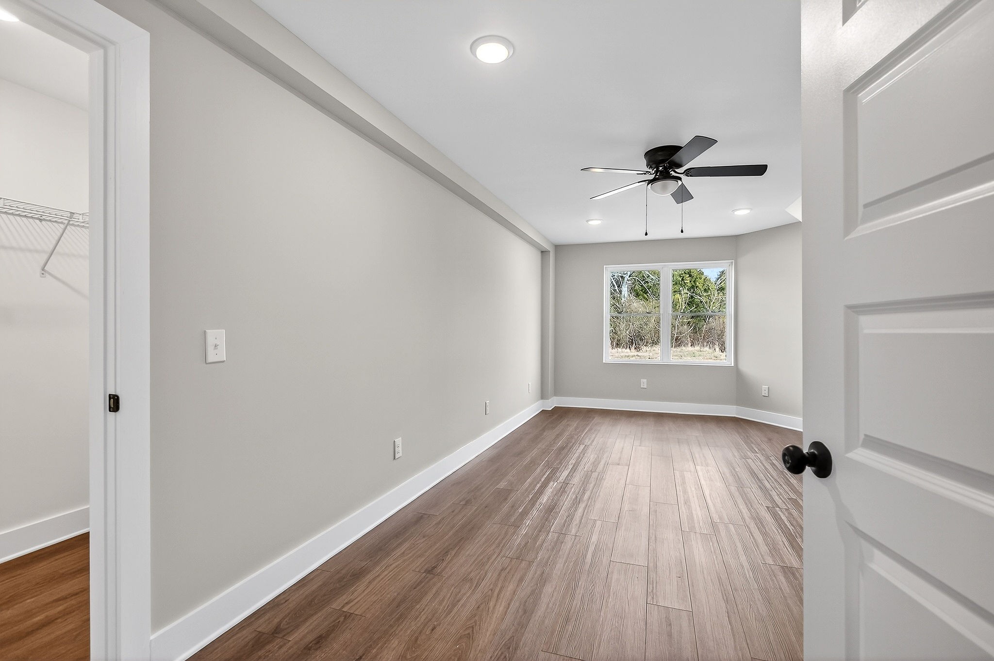698 Mike Muncey Road McMinnville, TN 37110 - Photo 44 of 71 a view of an empty room with a window and wooden floor