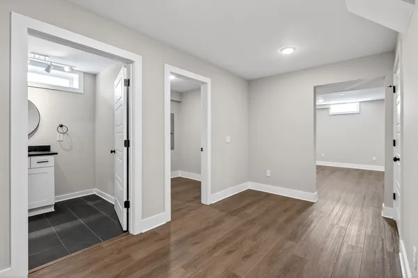 an aerial view of ocean and residential houses with outdoor space