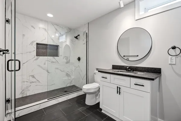 aerial view of a house with a yard and mountain